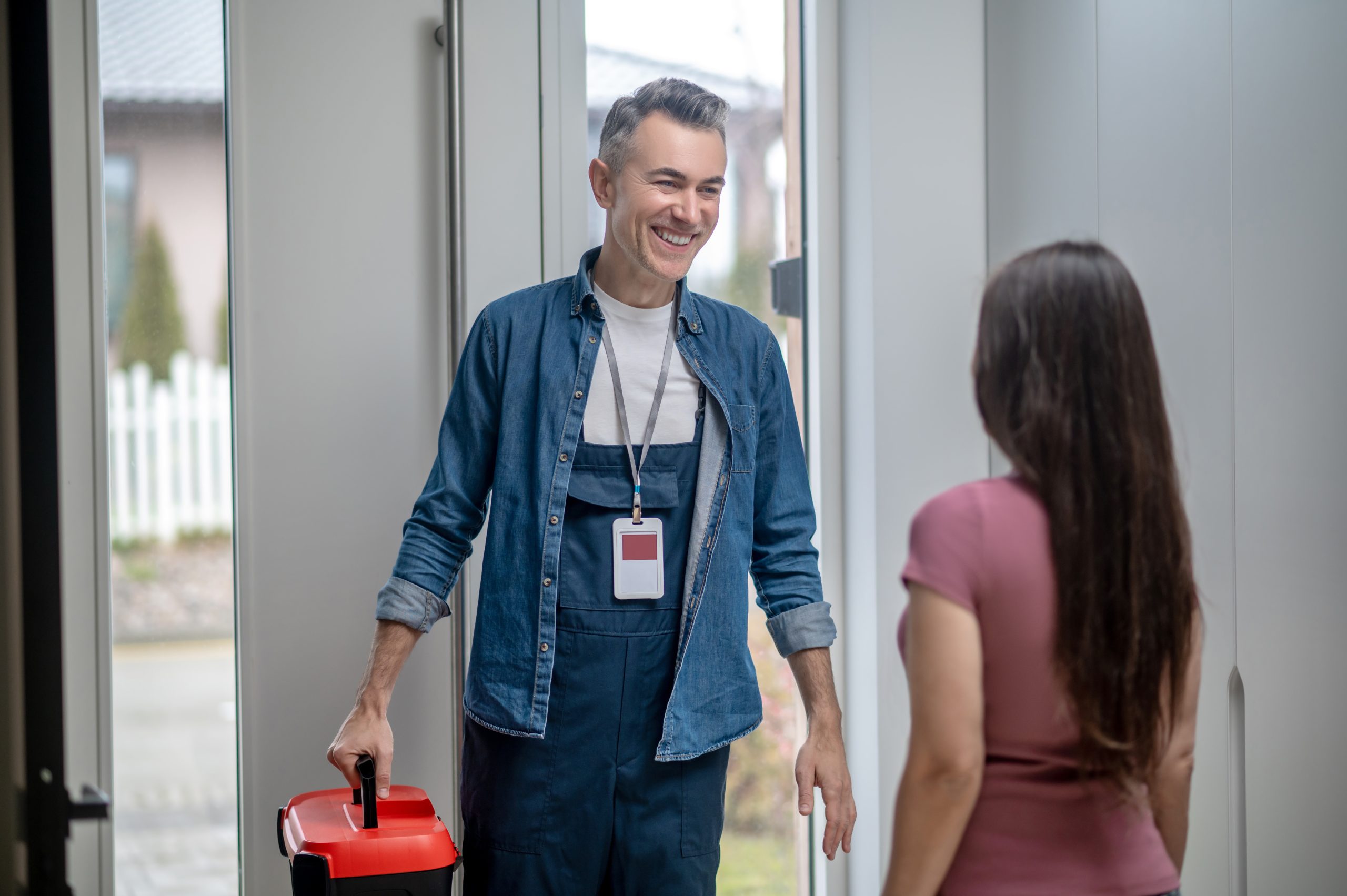 Joyful man with suitcase of tools and woman